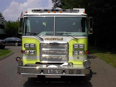 Front exterior view showing grille, bumper, and warning lights