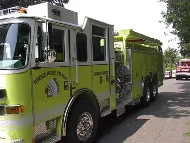 Driver-side cab view showing front door, side window, and wheel area