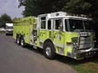 Tanker-pumper front-left exterior view showing enclosed cab and long body