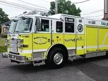 Wide front-left thumbnail view of the rescue pumper parked by the station.