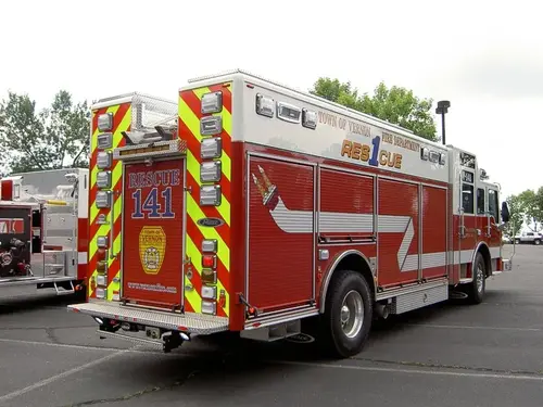 Rear-left exterior view showing side compartments and upper body stripe