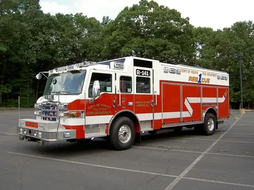 Driver-side profile view showing full pumper body and wheelbase
