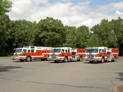 Wide side view showing multiple apparatus parked in formation