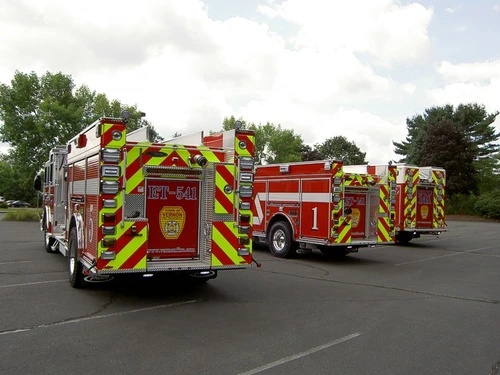 Rear view of apparatus showing red-and-yellow chevrons and hosebed area