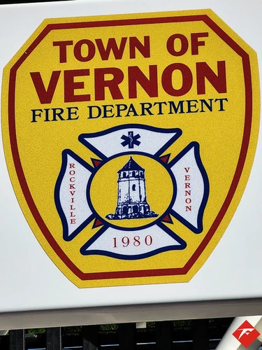 Cab door close-up showing shield-style fire department crest