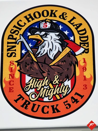 Cab door close-up showing circular company patch with bird graphic