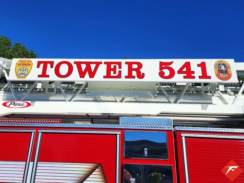 Body side close-up showing raised tower-unit lettering above compartments