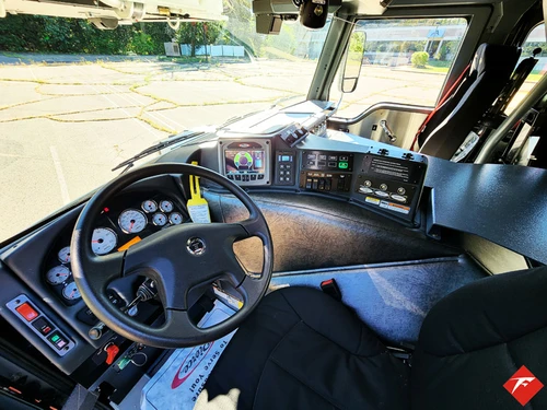 Driver cockpit view showing steering wheel, dashboard, and center console