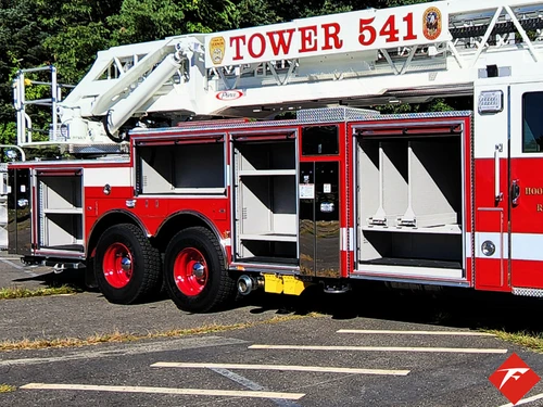 Driver-side profile showing open side compartments and tandem axle layout