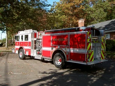 Rear-right exterior view with rear chevrons, side compartment doors, and rear wheel area.