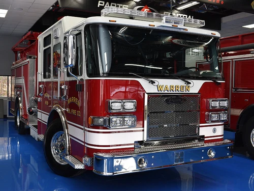 Pumper front-left exterior view showing grille, bumper, and cab