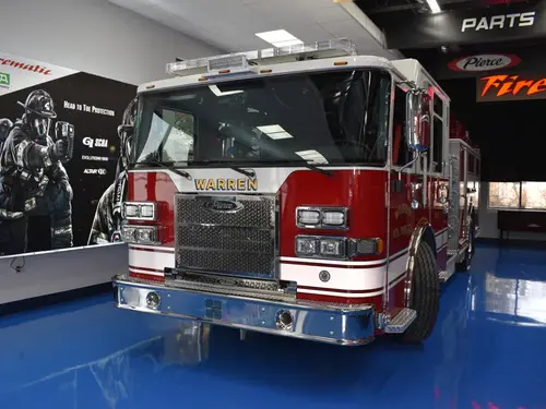Head-on front view showing grille, bumper, and warning lights