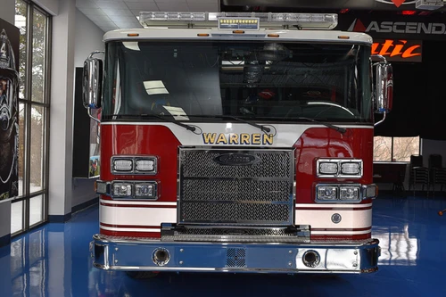 Head-on front view showing grille and cab inside apparatus bay