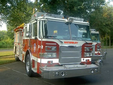 Pumper front-left exterior view showing enclosed cab and side compartments