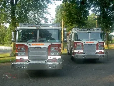 Front view of two pumpers showing grilles, light bars, and bumper details