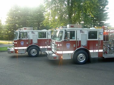 Two-apparatus side profile view showing pumper bodies and wheel areas