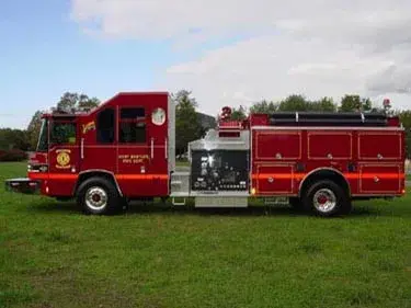 Driver-side full profile showing side compartments and midship pump panel