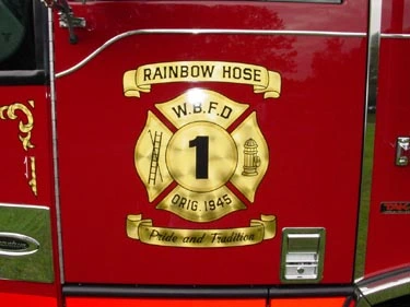 Cab door emblem close-up showing Rainbow Hose Company crest