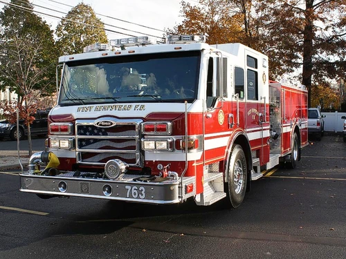 Pumper front-left exterior view showing cab, grille, and side body