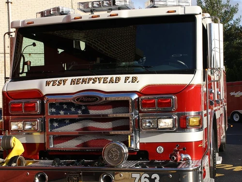 Head-on front view showing grille, bumper, and warning lights