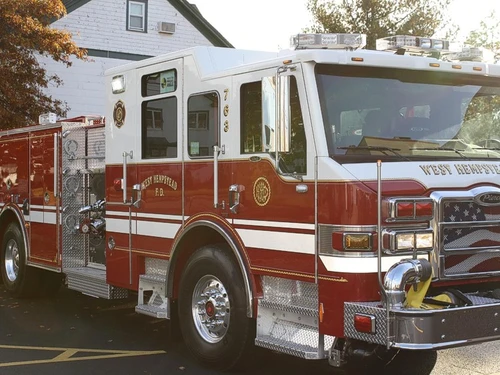 Front-left exterior view showing side body and wheelbase
