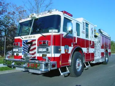 Pumper front-left exterior view showing enclosed cab and side compartments