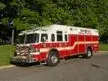 Wide front-left view of the rescue truck parked roadside with full body length visible.