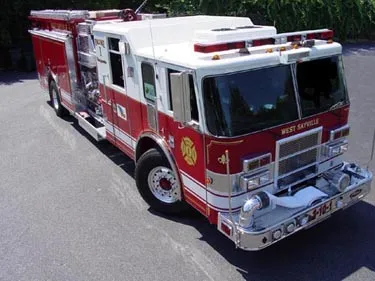High front-left exterior view showing bumper, cab, and side compartments