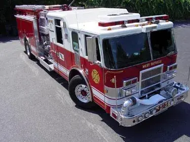 High front-left exterior view showing bumper, cab, and side compartments