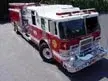 High front-left exterior view showing bumper, cab, and side compartments