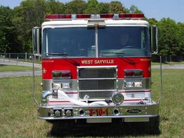 Front exterior view showing grille, bumper, and warning lights