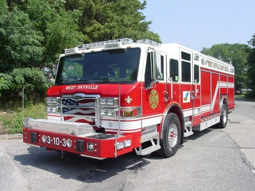 Front-left exterior view of a heavy rescue truck showing the enclosed cab, side compartments, and rear body.