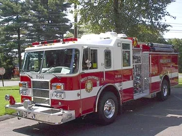Pumper front-left exterior view showing enclosed cab and side compartments