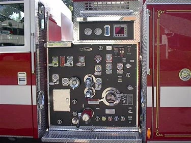 Pump panel close-up showing gauges, valves, and intake connections