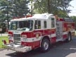 Pumper front-left exterior view showing enclosed cab and side compartments