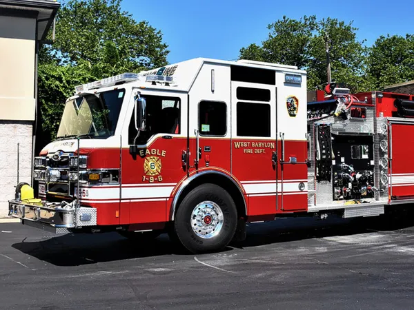 Pumper front-left exterior view showing enclosed cab and side pump panel