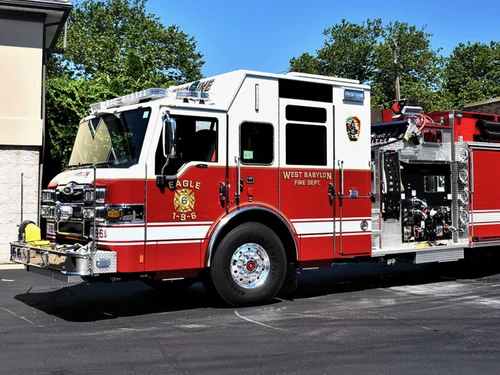 Pumper front-left exterior view showing enclosed cab and side pump panel
