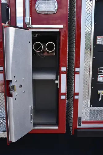 Open narrow side compartment showing upright storage bay and fittings