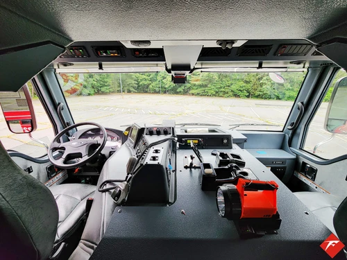 Cab interior view showing front seats, dashboard, and center console area
