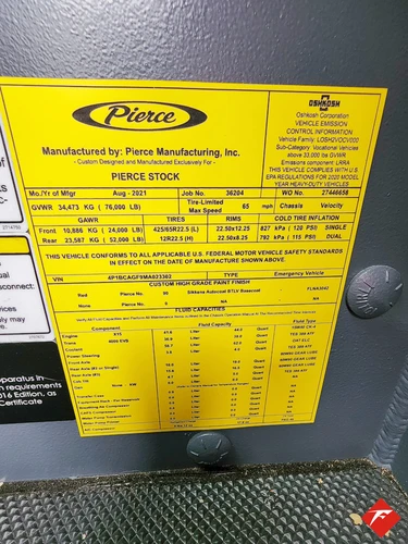 Cab door-jamb close-up showing yellow specification label plate