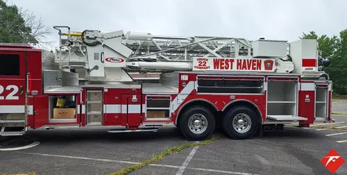 Driver-side profile view showing full apparatus length and ladder sections