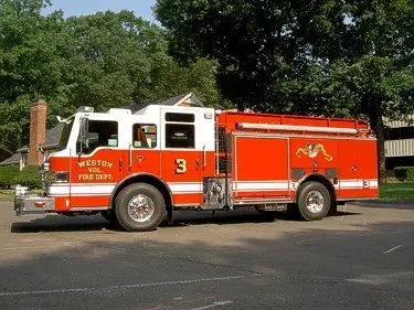 Driver-side profile view showing pump panel area and side body compartments