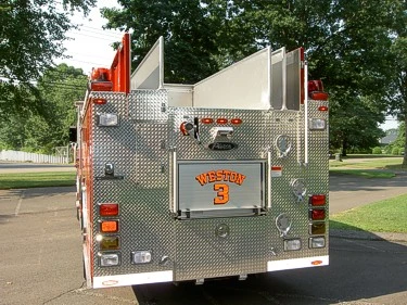 Rear view showing rear body panel, hosebed divider fins, and warning lights