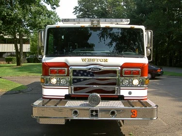 Front exterior view showing grille, bumper, and warning lights