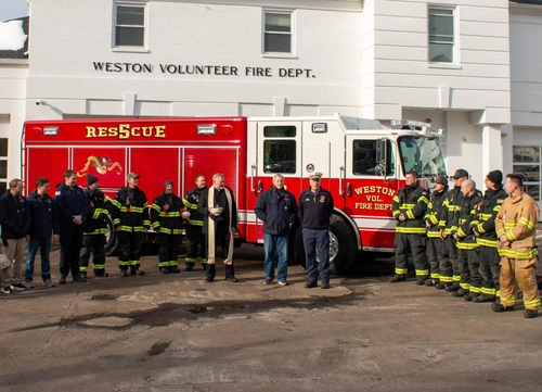 Weston Pierce heavy rescue group photo in front of the station with firefighters posed beside the truck