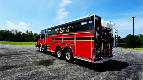 Driver-side profile view showing long rescue body and side compartments