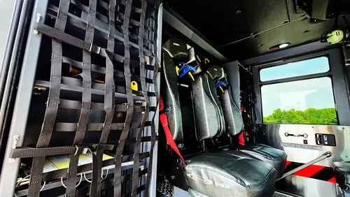 Crew seating area view showing SCBA seats and cargo net storage