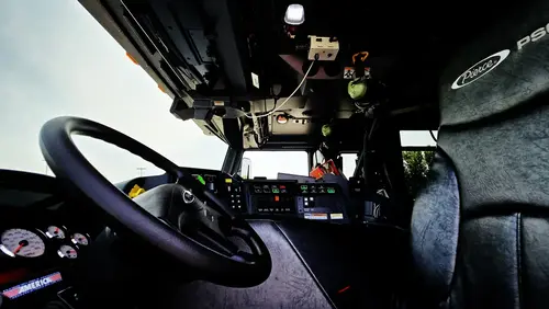 Cab interior side view showing center console and front passenger area