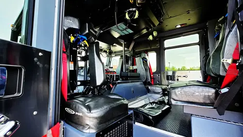 Cab rear-facing view showing center console and crew seat area