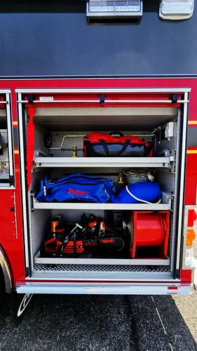 Open side compartment showing lower tray with rescue gear